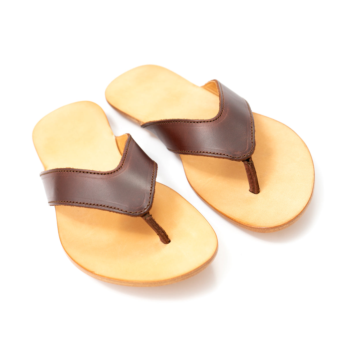 Pair of Flip Flops in Chestnut leather with V-shaped thong straps and natural footbeds, front angled view