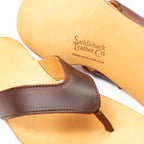 Close-up of Flip Flops in Chestnut leather showing the strap and Made in Old Mexico logo stamp on the sole