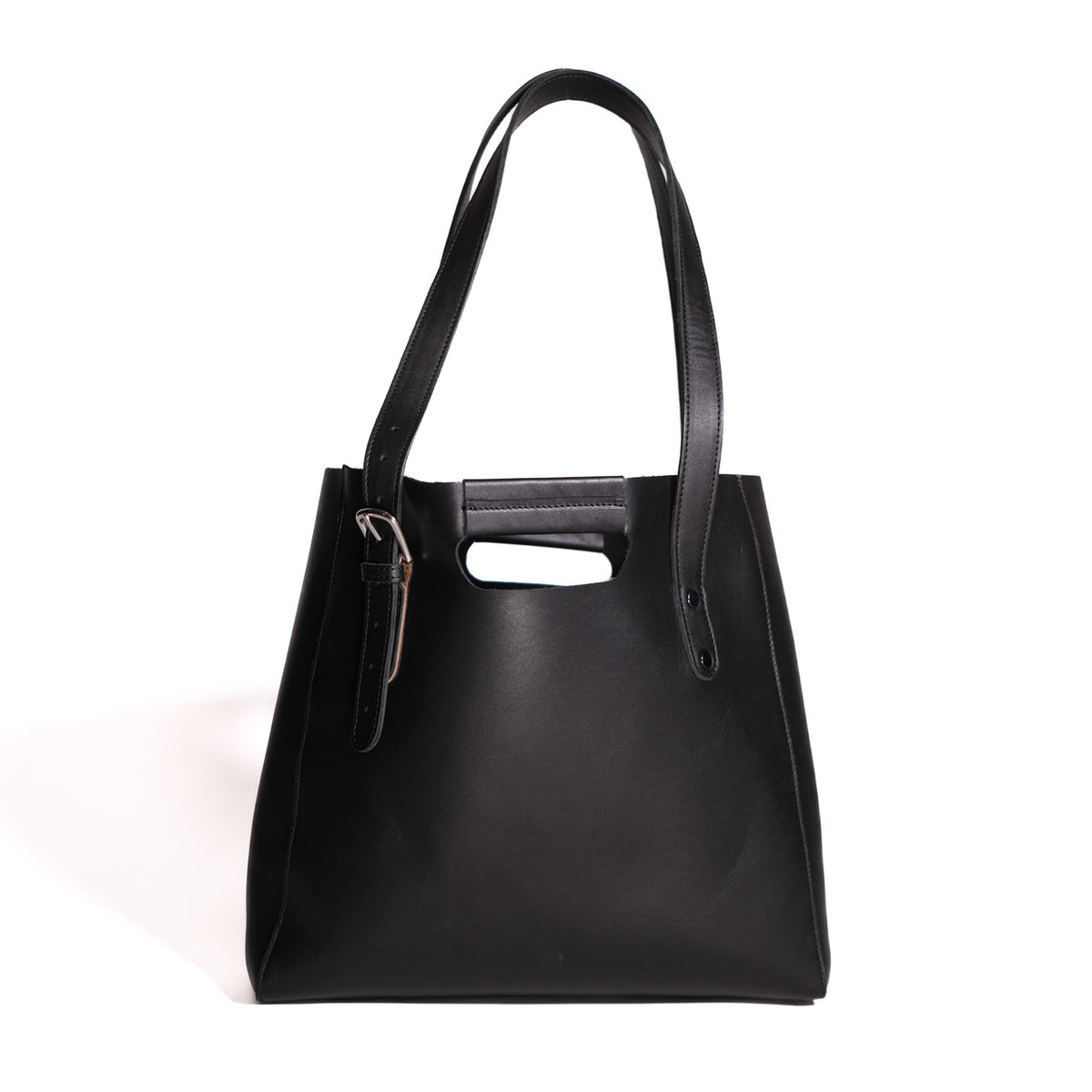Everyday Leather Tote in Black, back view with shoulder handles, cutout grip and buckled side strap