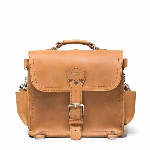 Photographer's Satchel in Tobacco, front view with buckled flap, top handle and side pockets