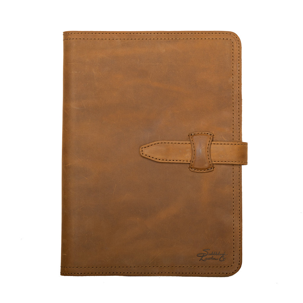 Large Leather Portfolio in Tobacco, closed, straight-on front view with strap closure and embossed logo