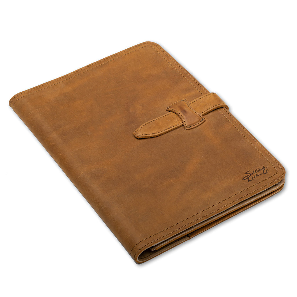 Large Leather Portfolio in Tobacco, closed, angled view showing strap closure and embossed logo