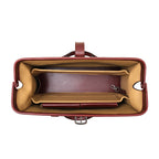 Spurgeon Briefcase in Oxblood, top-down view of the open frame mouth showing tan-lined compartments