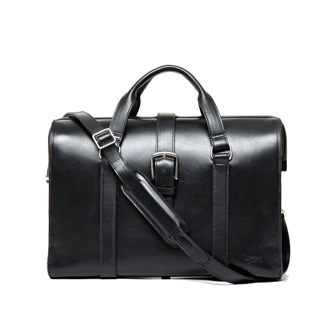 Spurgeon Briefcase in Raven Black, front view with center buckle strap, top handles and shoulder strap