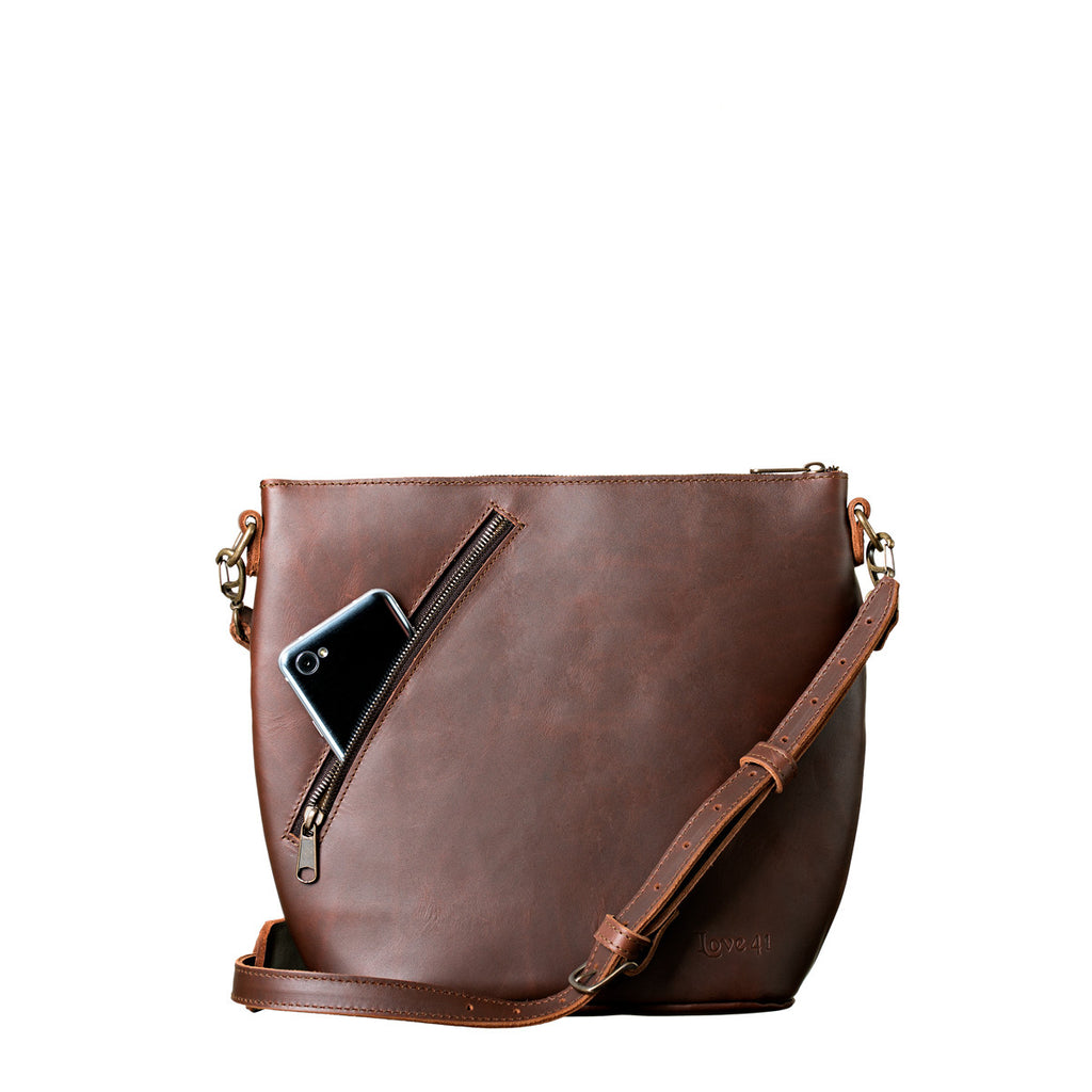 Crossbody Concealed Leather Bag in Chestnut, phone tucked in the diagonal zipper pocket