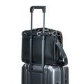 Leather Luggage Strap in Black holding a black leather bag on top of a rolling suitcase by its handle