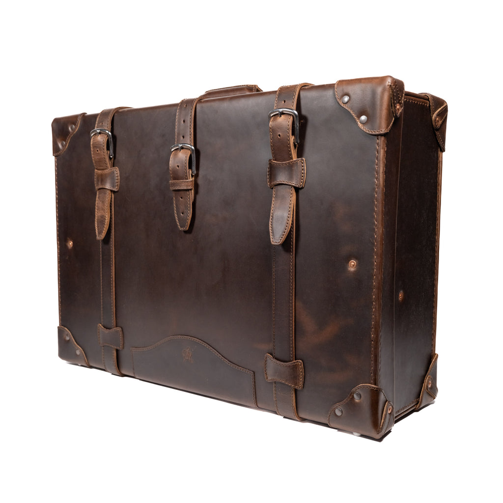 Grandfather Suitcase in Dark Coffee Brown, angled front view with buckle straps and riveted corner caps