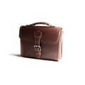 Front Pocket Leather Satchel in Chestnut, angled front view with top handle and buckled front pocket