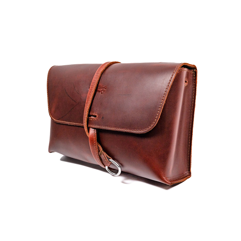 Large Leather Organizer Bag in Chestnut, closed flap with wrapped leather tie and ring, angled view