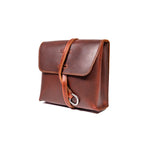Leather Organizer Bag in Chestnut, angled front view with flap closure and strap looped through a metal ring