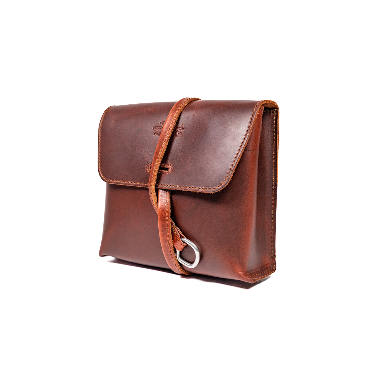 Leather Organizer Bag in Chestnut, angled front view with flap closure and strap looped through a metal ring