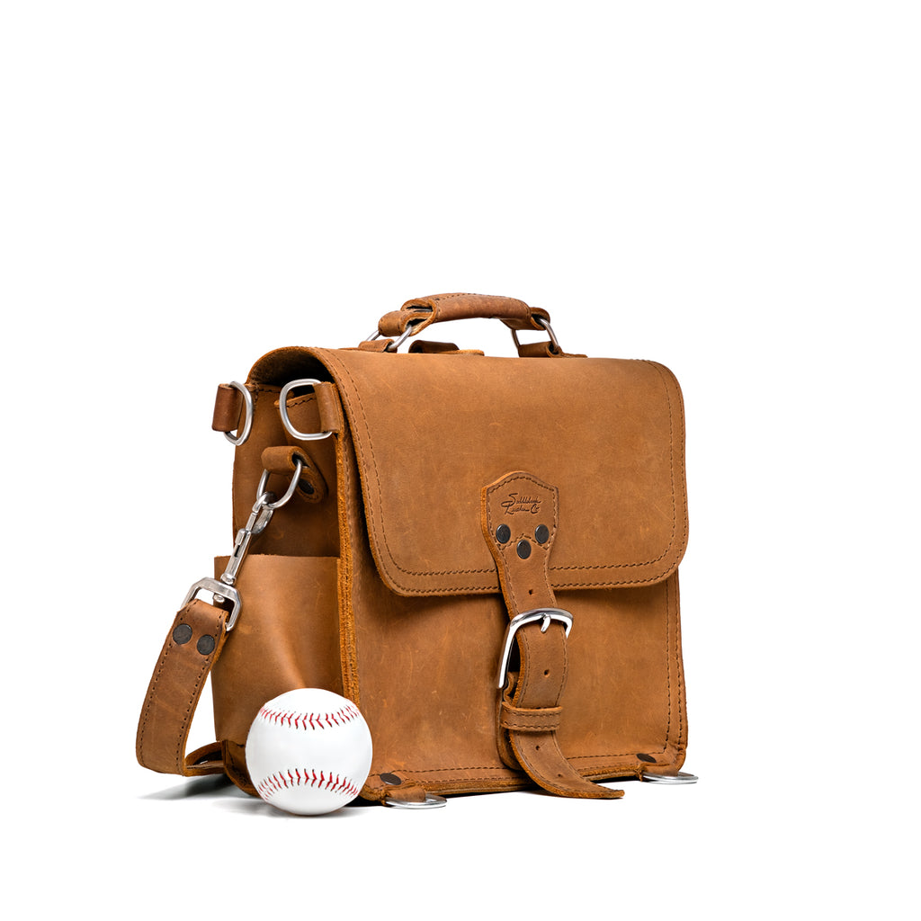 Photographer's Satchel in Tobacco, angled front view with a baseball for size