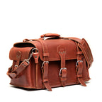 Side Pocket Leather Duffle in Chestnut, angled front view with buckle straps, side pocket and shoulder strap