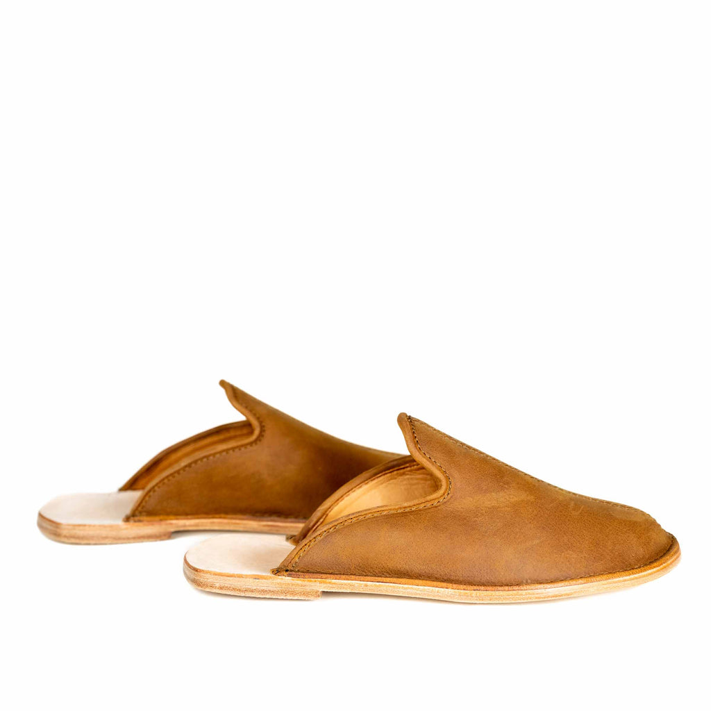 Pair of Barefoot Slip-on Mules in Tobacco leather with open backs and natural soles, side view