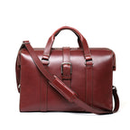 Spurgeon Briefcase in Oxblood, front view with center buckle strap, top handles and shoulder strap