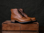 Huntsman Boots in Natural, pair with dark laces and lug soles on a wooden crate