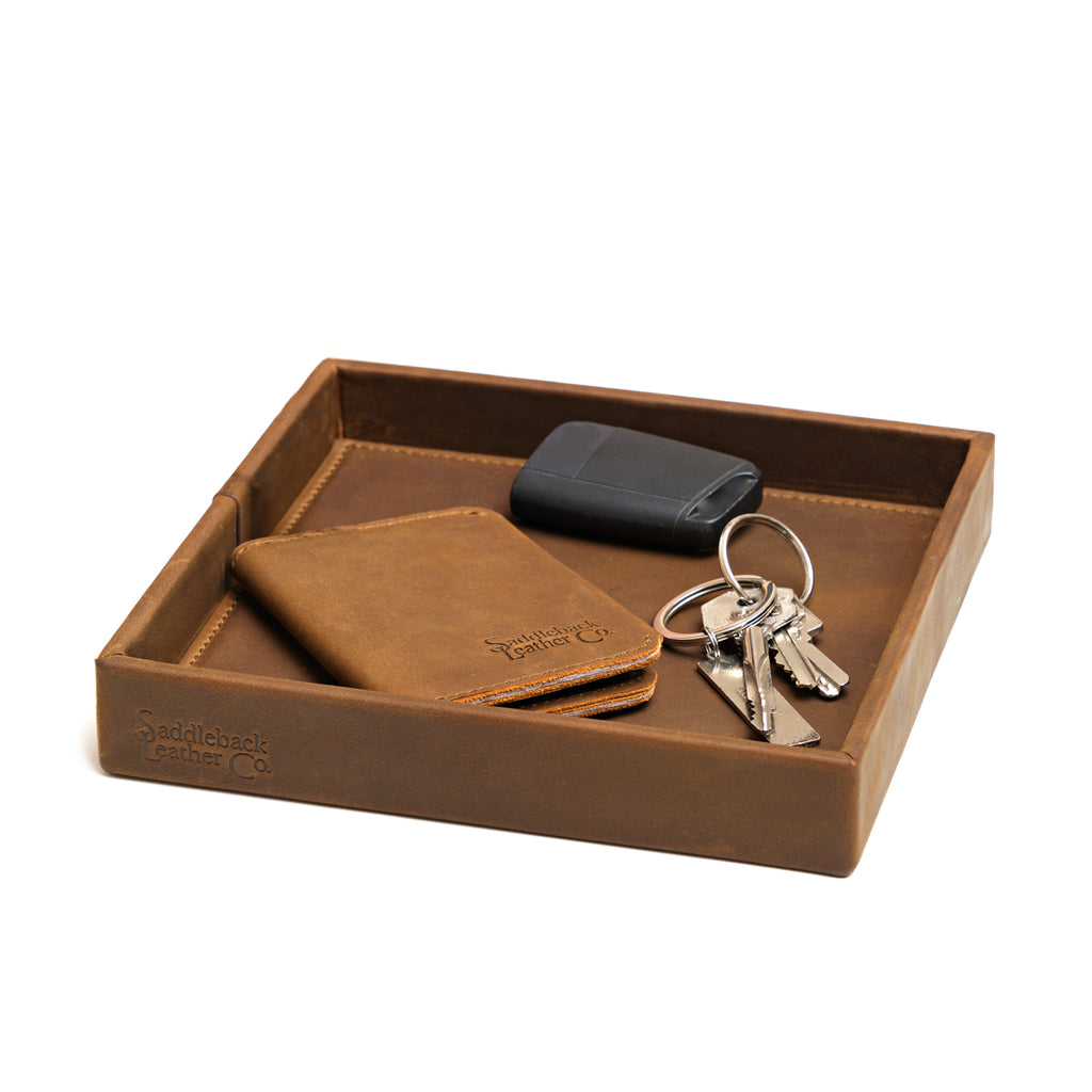 The Simple Leather Valet Tray in Tobacco holding a leather card wallet, key fob and keys, angled view