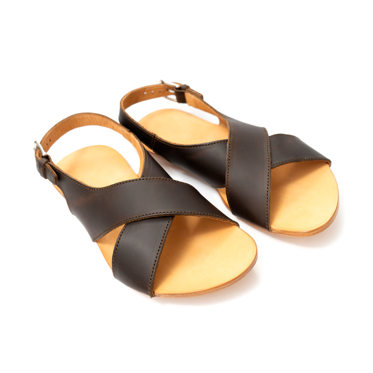 Pair of Jesus Sandals in Dark Coffee Brown leather with crisscross straps and tan footbeds, angled view