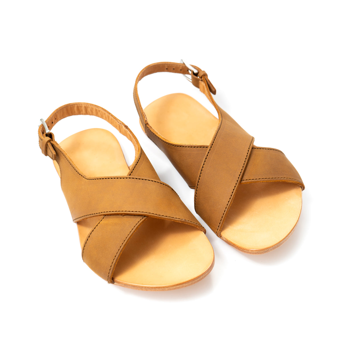 Pair of Jesus Sandals in Tobacco leather with crisscross straps and buckled ankle straps, angled view