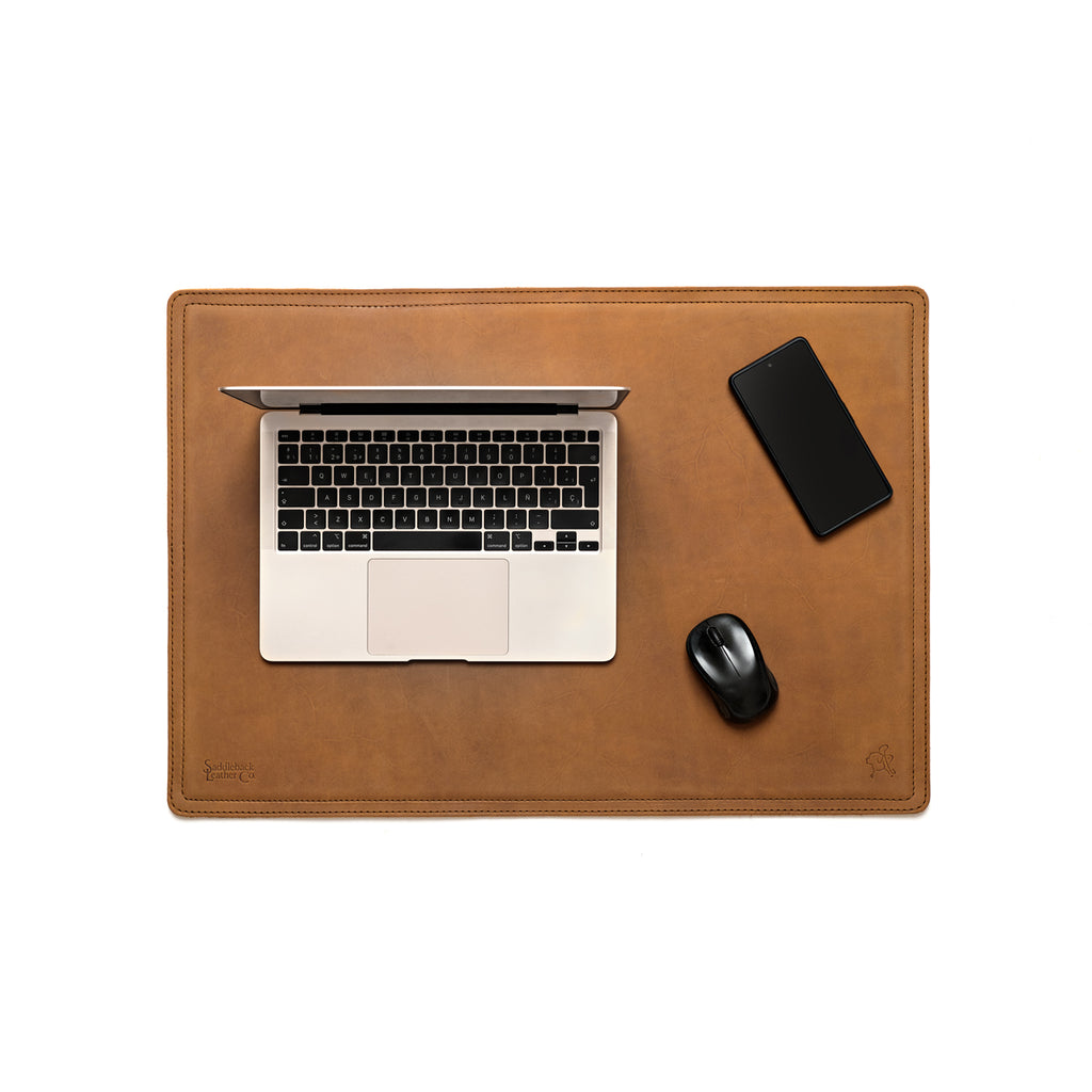 Desk Pad in Tobacco leather, top-down view with a laptop, smartphone and mouse