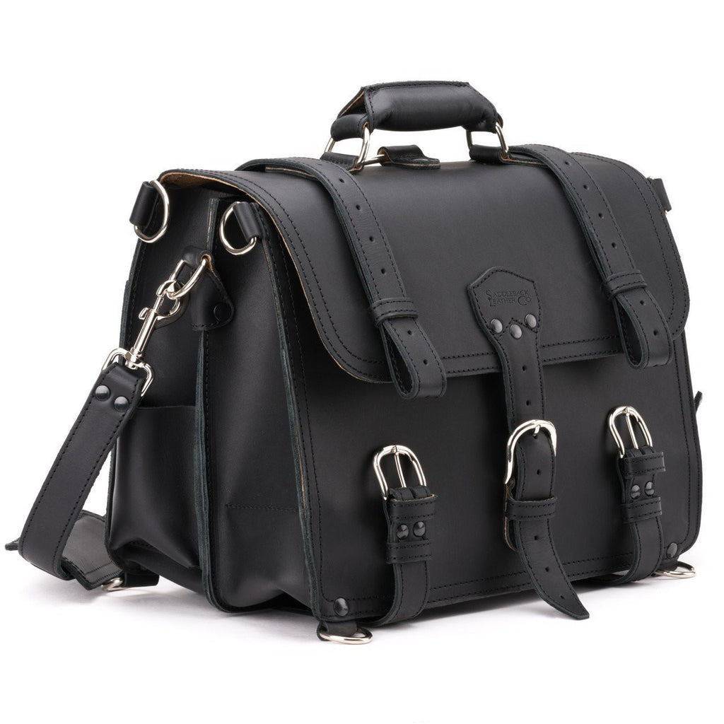Large Classic Leather Briefcase in Black, angled side view with buckled flap straps, side pocket and shoulder strap