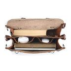 Large Classic Leather Briefcase in Chestnut, top view open with books, laptop, mouse, cable and keys in its pockets