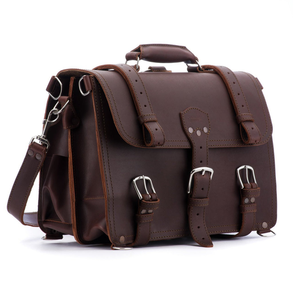 Large Classic Leather Briefcase in Chestnut, angled side view with buckled flap straps, side pocket and shoulder strap