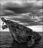 Large Classic Leather Briefcase, black and white photo of it hanging from the bow of a shipwreck under stormy clouds