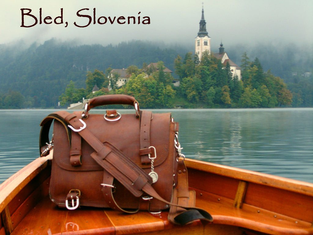 Large Classic Leather Briefcase in Chestnut in a wooden boat on Lake Bled, Slovenia, with the island church behind