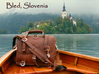 Large Classic Leather Briefcase in Chestnut in a wooden boat on Lake Bled, Slovenia, with the island church behind