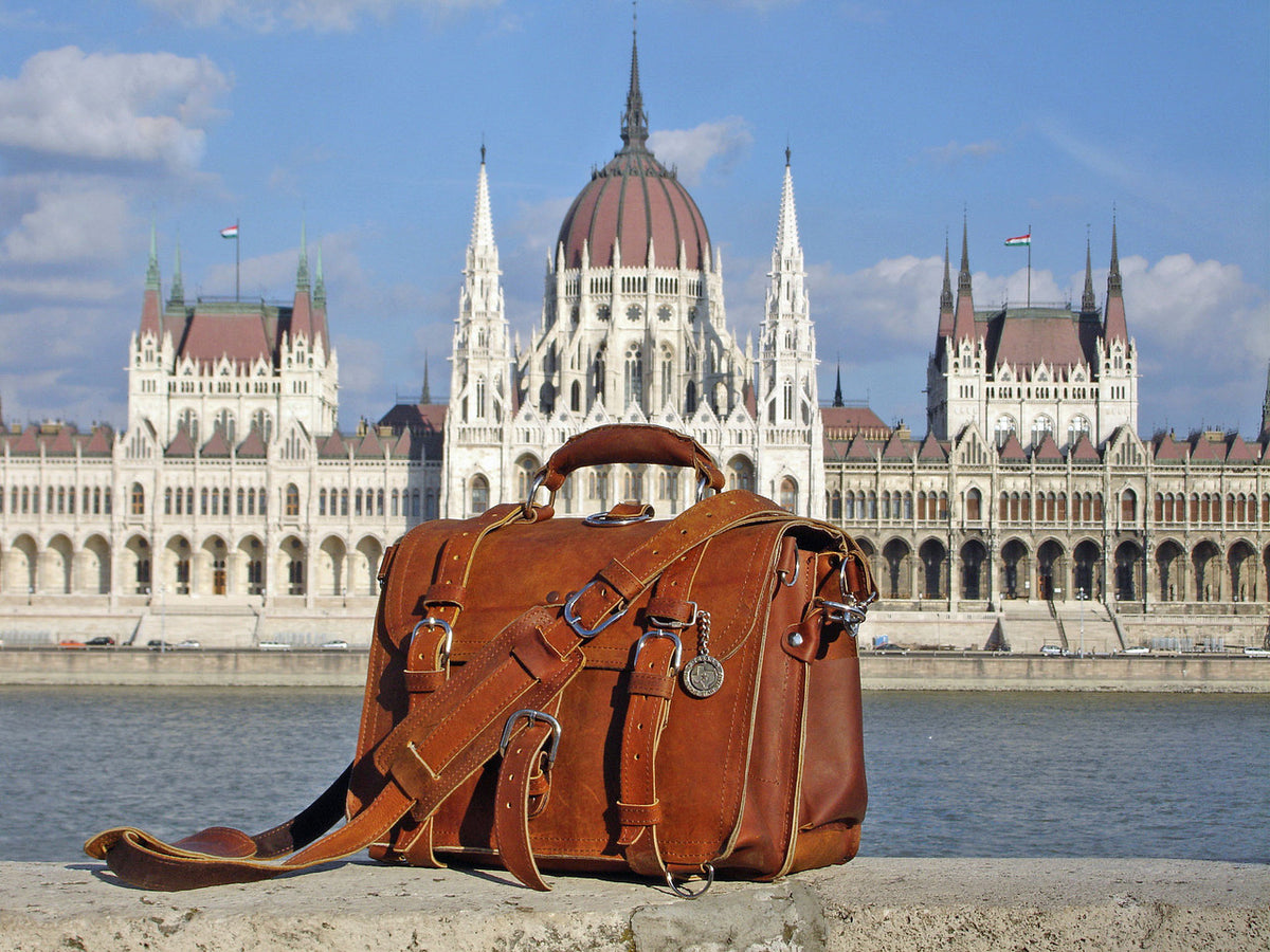 Large Classic Leather Briefcase in Chestnut on a riverside wall across from the Hungarian Parliament Building
