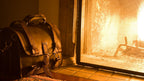 Large Classic Leather Briefcase beside a glowing fireplace on a tiled hearth in warm firelight
