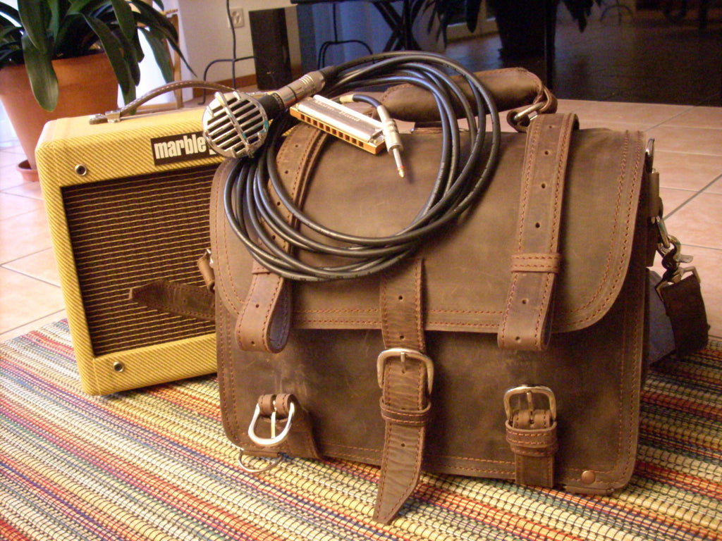 Large Classic Leather Briefcase in Dark Coffee Brown on a striped rug with a microphone, cable and harmonica by an amp