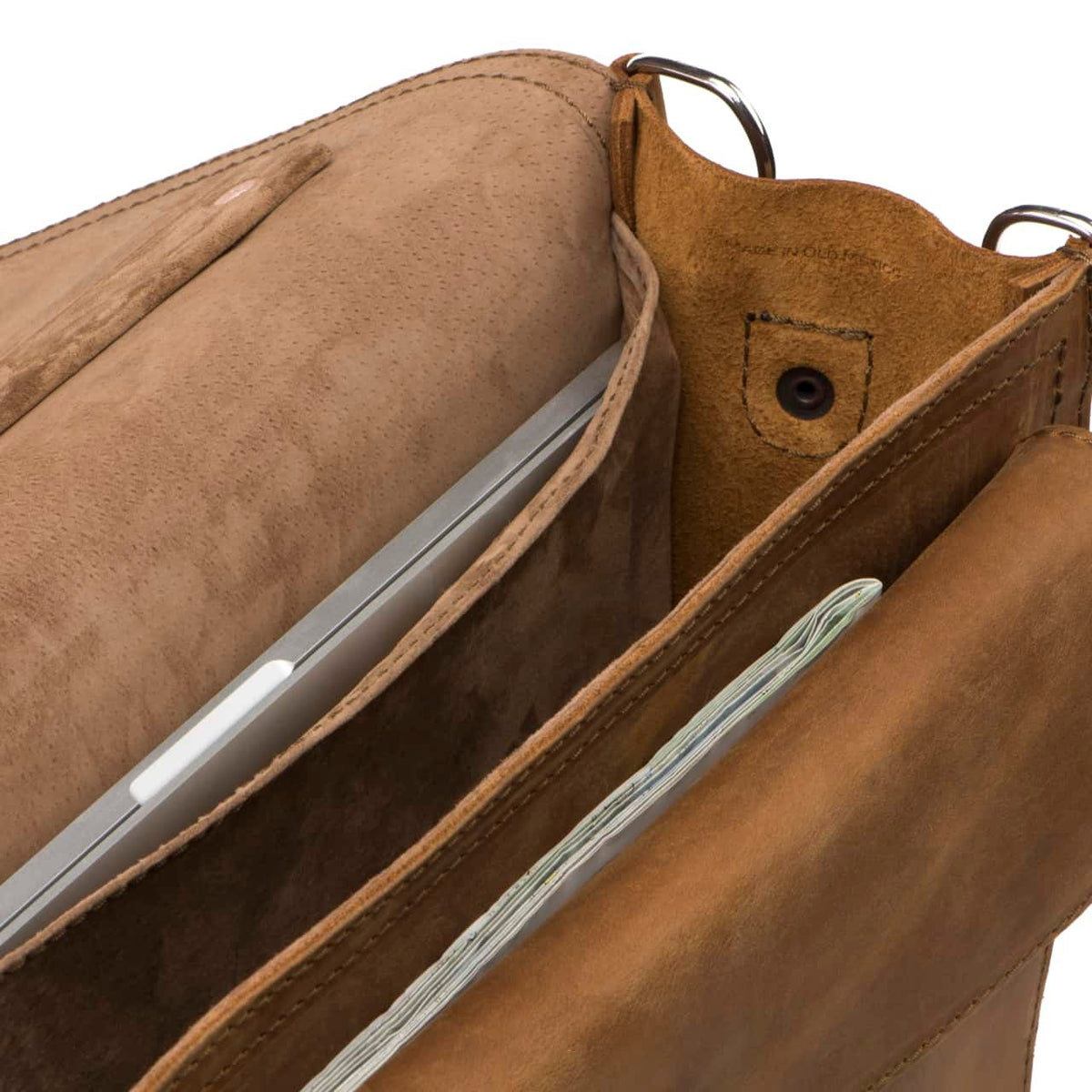 Slim Leather Briefcase in Tobacco, close-up inside view of the pigskin-lined compartments holding a laptop and papers