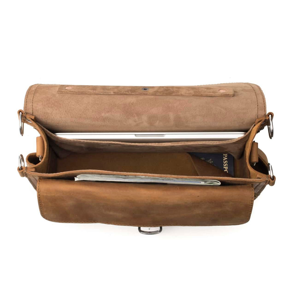 Slim Leather Briefcase in Tobacco, top view open showing a laptop, passport and papers inside
