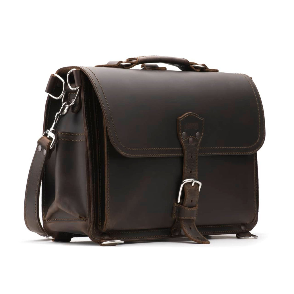 Slim Leather Briefcase in Dark Coffee Brown, angled front view with buckled flap, top handle and shoulder strap