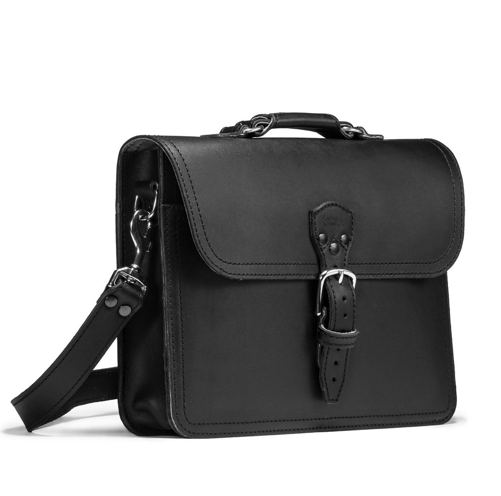 Fourteener Thin Leather Briefcase in Black, angled front view with top handle, buckled flap and shoulder strap