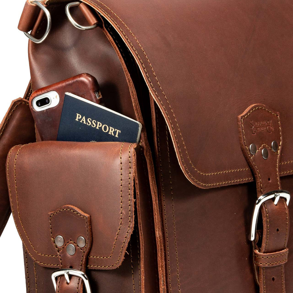 Tank Backpack in Chestnut, close-up of side pocket holding a phone and passport