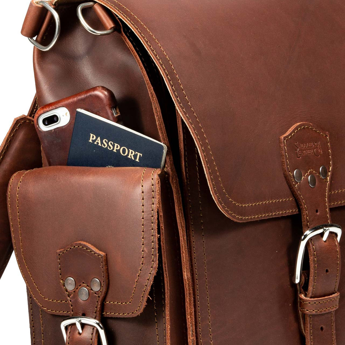 Tank Backpack in Chestnut, close-up of side pocket holding a phone and passport