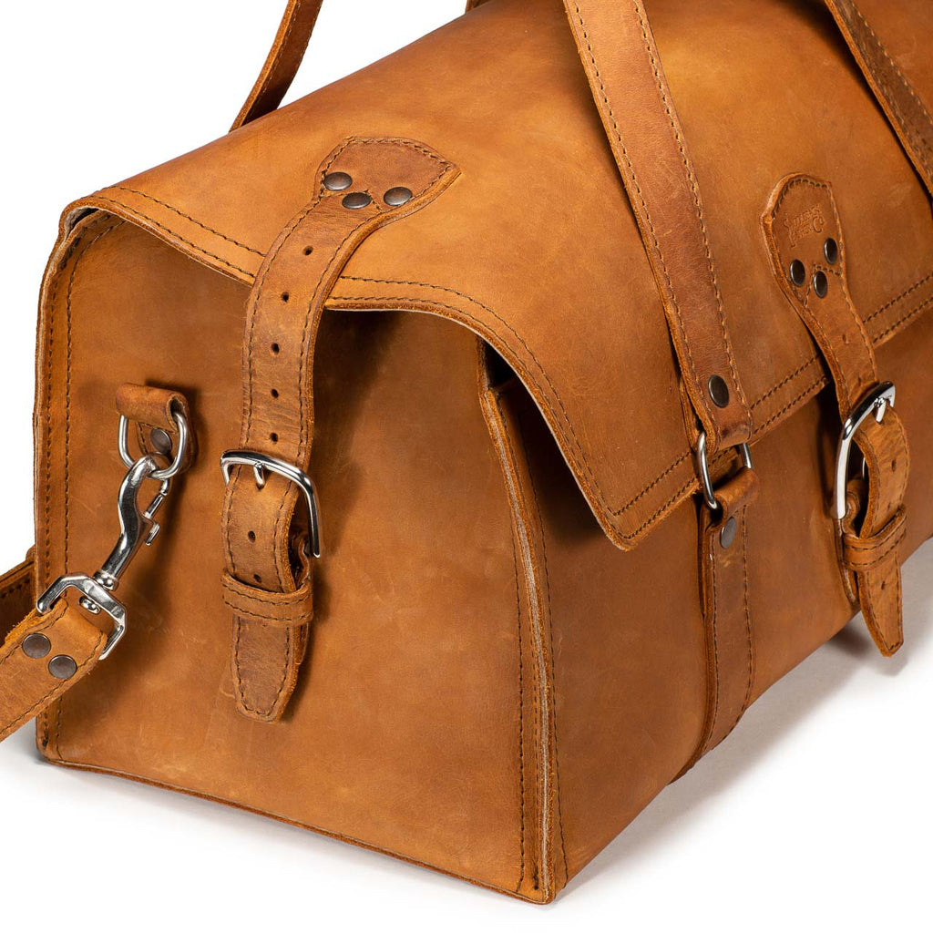20" Baby Beast Duffle Bag in Tobacco, close-up of end buckle strap, swivel hook and flap stitching