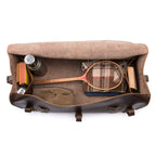 34" Beast Duffle Bag in Dark Coffee Brown, top view packed with a wooden tennis racket, thermos, shoes and books
