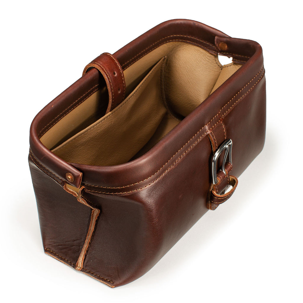Little Big Mouth Toiletry Bag in Chestnut, angled view with the frame mouth open showing the lined interior
