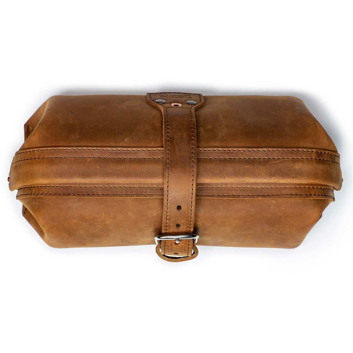 Little Big Mouth Toiletry Bag in Tobacco, top view closed with the leather strap buckled over the frame