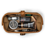 Little Big Mouth Toiletry Bag in Tobacco, top view open and packed with men's grooming products and a comb