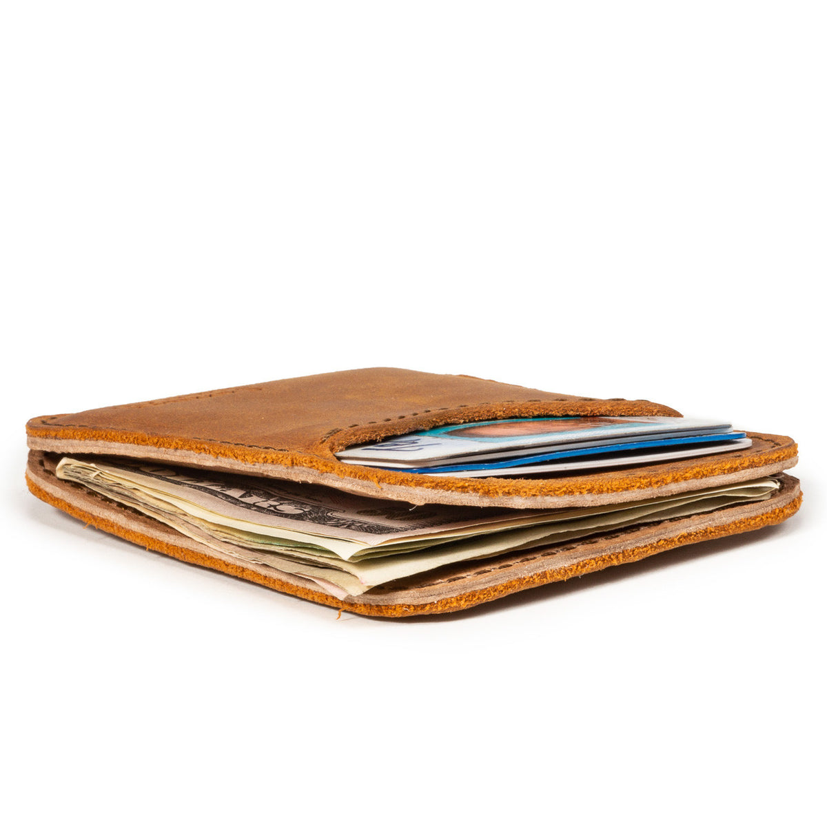 Slim Leather Card Wallet in Tobacco, low side view lying flat and stuffed with cards and cash