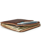 Slim Leather Card Wallet in Chestnut, low side view lying flat and stuffed with cards and cash