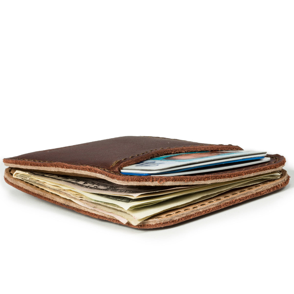 Slim Leather Card Wallet in Chestnut, low side view lying flat and stuffed with cards and cash