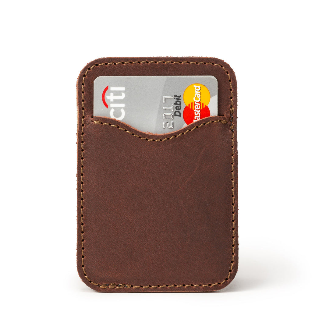 Slim Leather Card Wallet in Chestnut, back view with a debit card tucked in the curved pocket