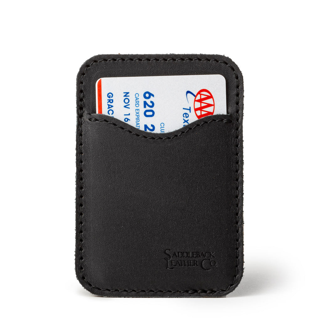 Slim Leather Card Wallet in Black, front view with a card tucked in the curved front pocket