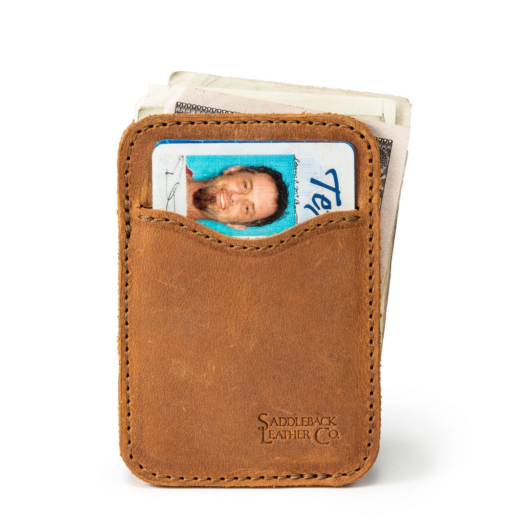 Slim Leather Card Wallet in Tobacco with an ID card in the front pocket and folded cash behind